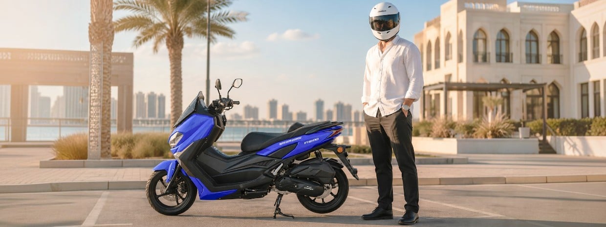 Rider in a white shirt and helmet standing next to a blue FX 200 maxi scooter on a city street