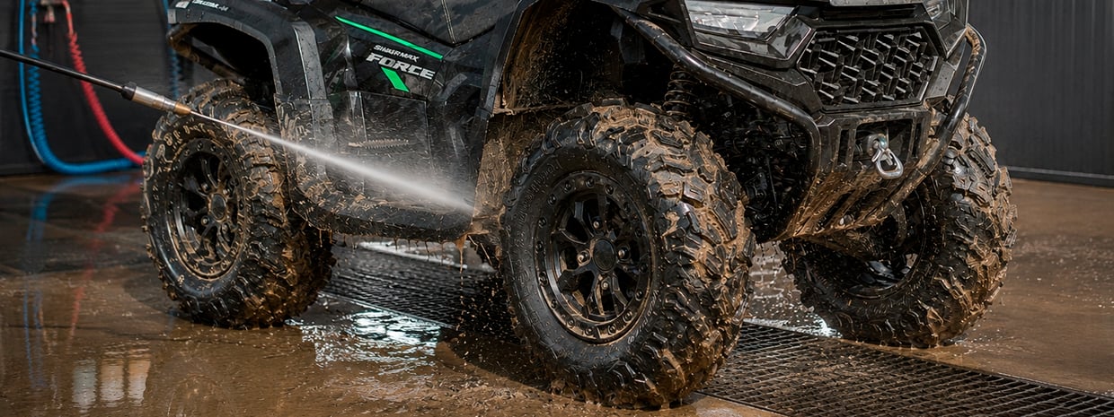 ATV covered in mud and sand after an off-road ride