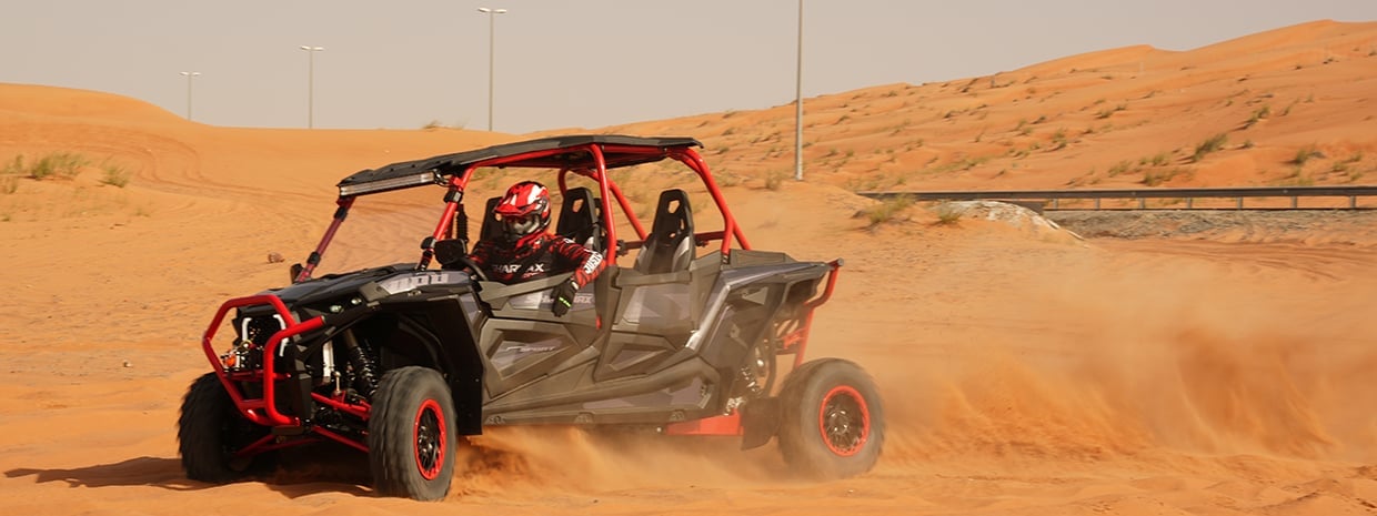 Sports buggy in dynamics on the dunes Sharmax XForce 1100 Sport x4 in dynamics on the dunes