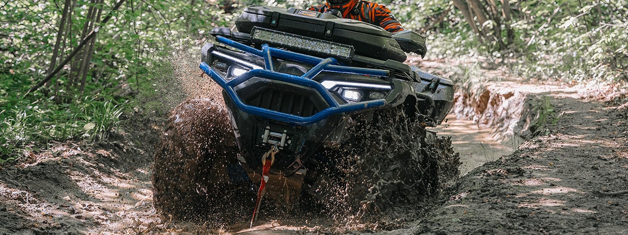 ATV crossing a muddy water ford